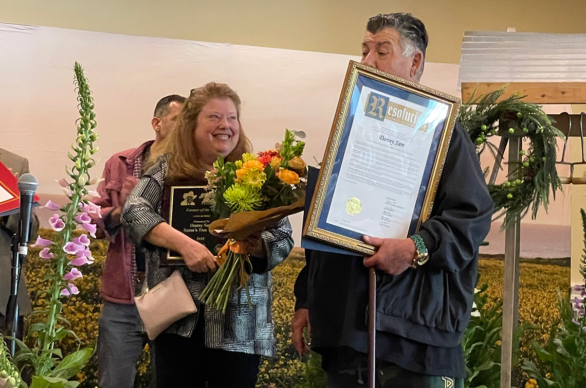 Natalie and Dan Sare receiving the 2025 Farmer of the Year award